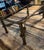 The base is built with heavy cylindrical legs, round bun feet, and an X-frame stretcher accented with sculptural, hand-...