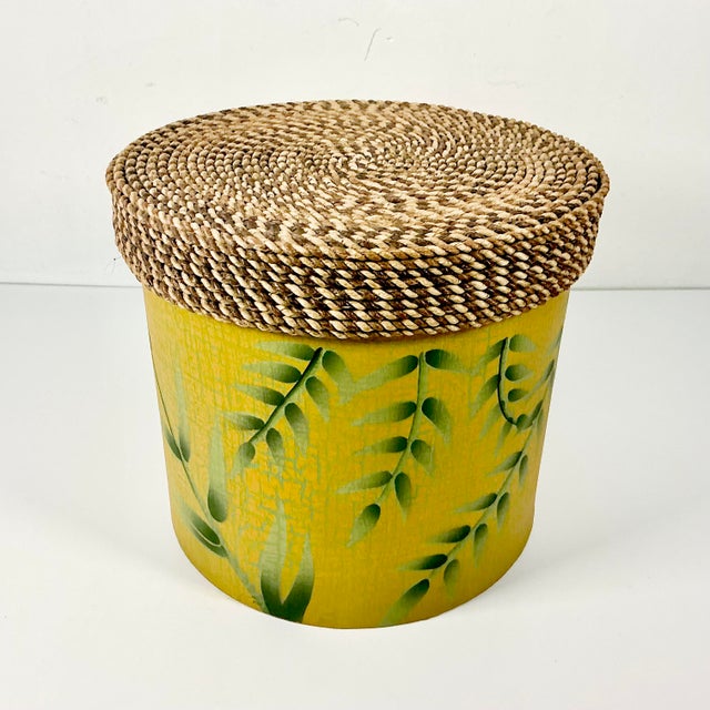 This is a really nice decorative storage box. The round box features a wicker rope lid over a Bamboo leaf motif covered...