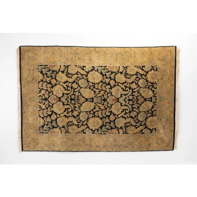 Vintage Tabriz rug with a floral motif in black and gold wool and silk. Circa 1950.