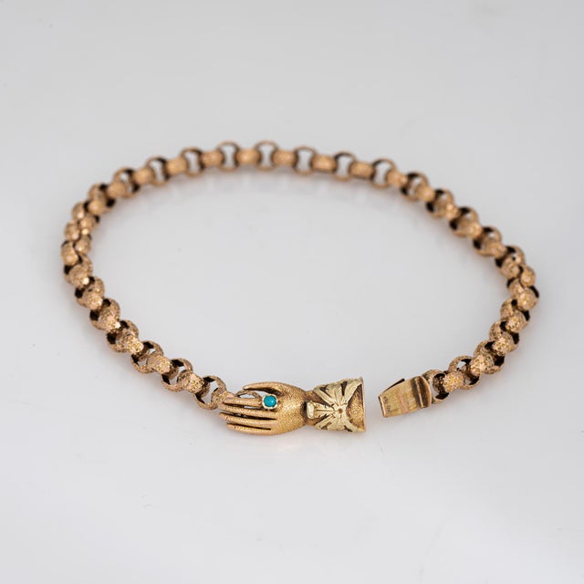 Finely detailed antique Georgian hand clasp bracelet (circa 1800s to 1830s), crafted in 14k yellow gold. The Georgian...