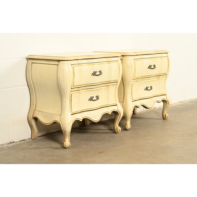 A beautiful pair of French Provincial Louis XV style two drawer nightstands By White Furniture USA, Circa 1970s Carved...