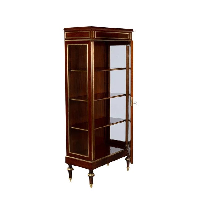 This sleek 19th century display cabinet brings the classic charm of French classicism into your home. Manufactured around...