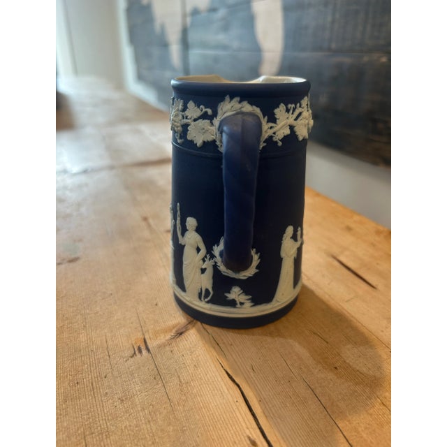 An elegant Wedgwood Jasperware lidded coffee pot in the iconic Portland blue with applied white neoclassical reliefs. The...