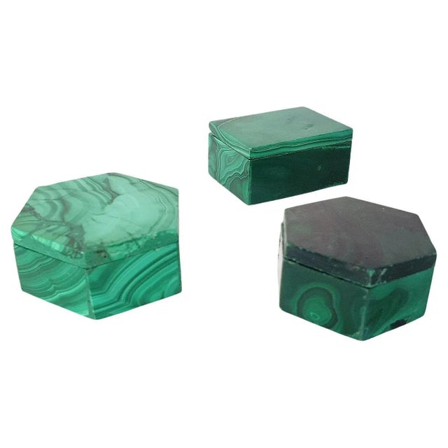 A set consisting of three handmade miniature boxes of malachite originating from Congo, Africa. Two boxes are hexagon and...