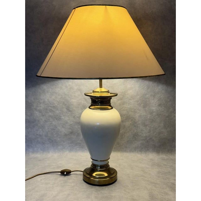 A refined Italian table lamp from the 1970s, featuring a sculptural glazed ceramic body complemented by elegant brass...