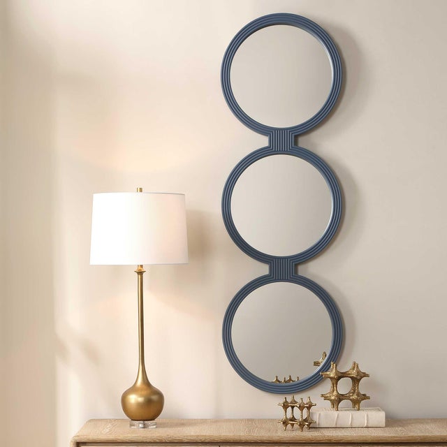 Three Interconnected Round Mirrors, Each Framed With A Continuous Ribbed Texture In A Muted Blue-gray Finish, Creating A...