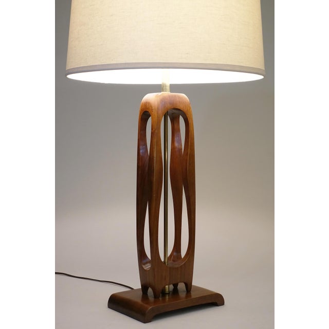 A unique and rare large Atomic Modern solid Walnut 3-D "Dogbone" cutout table lamp design in the manner of Adrian Pearsal...