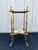 An ornate two tiered art nouveau planter stand constructed with brass and featuring polished onyx slates on each tier....