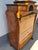 A substantial secretary desk with a hutch, featuring two drawers on the right and left, opened from the interior with...