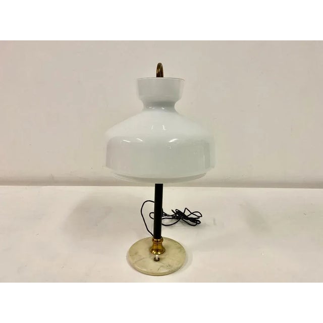 Table lamp White opaline glass shade Black metal stem Marble base Brass ring Italy 1950s UK Plug (up to 250V).The wiring...