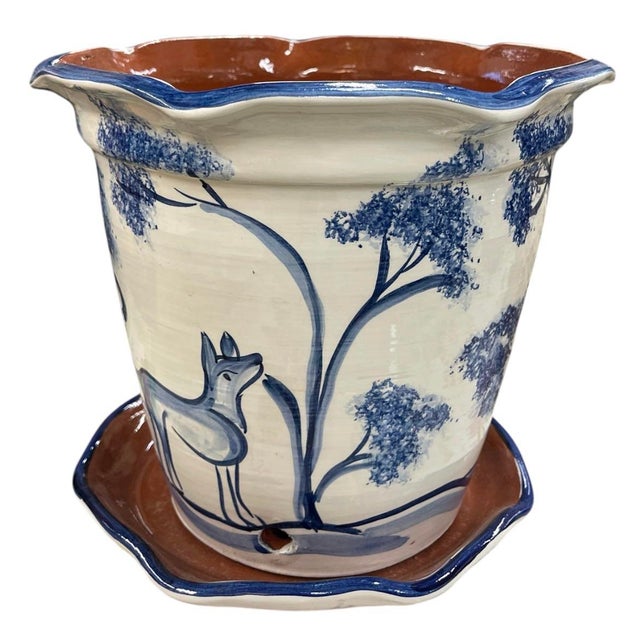 This charming hand-painted glazed ceramic planter pot comes complete with a matching attached-look drainage saucer base....