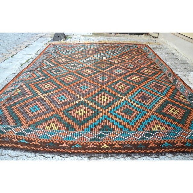 This is a vintage Turkish Anatolian kilim rug from the 1960s. The piece was hand-woven.