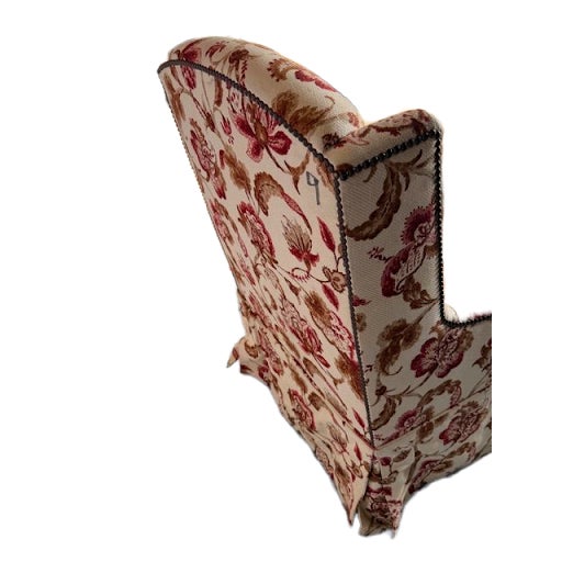 Charming pair of upholstered slipper chairs featuring a gently curved back and armless silhouette. The chairs are...