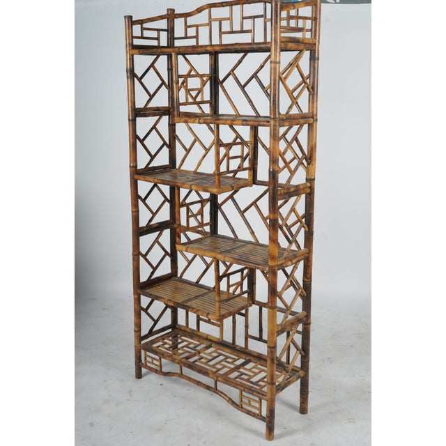 This stunning mid-to-late 20th century Chinese Chippendale-style etagere is expertly crafted from beautifully scorched...