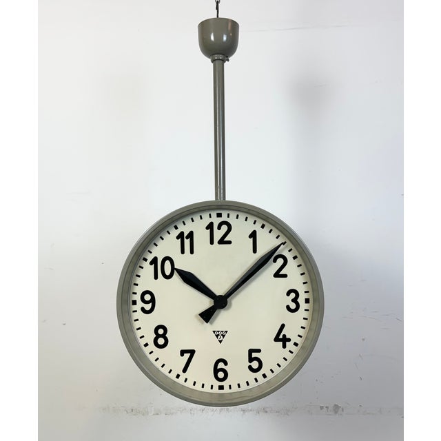 This large double sided railway or factory clock was produced by Pragotron, in former Czechoslovakia, during the 1950s....
