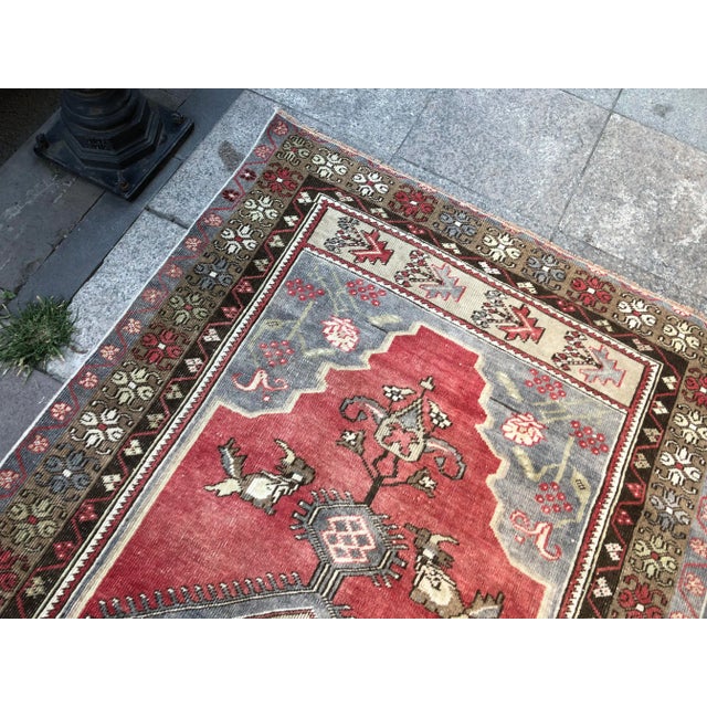This is a vintage Turkish Oushak rug from the 1960s. The piece was hand-knotted.