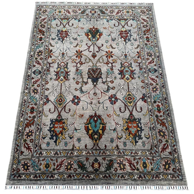A hand-knotted area rug in the Ziegler Sultanabad design, woven in Afghanistan on a pale silver-grey ground with large-...