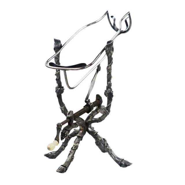 A rare wine decanter with a tilting pour mechanism, silver-plated, mounted on an expressive cast base with animalistic...