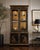 A striking Drexel Heritage illuminated display cabinet showcasing classic Chinoiserie design with intricate gilt...