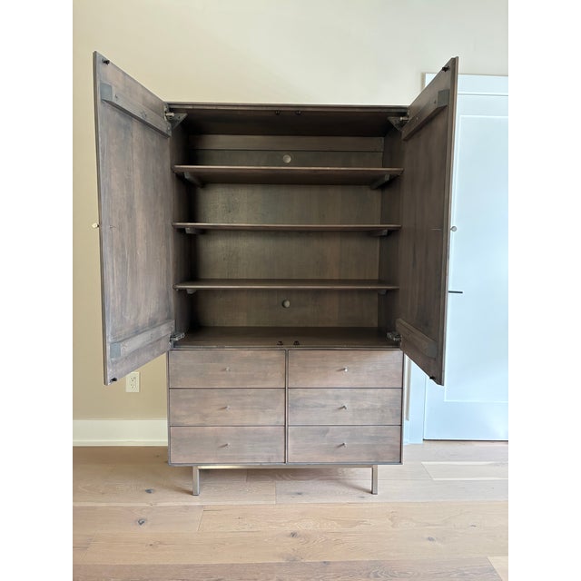 This Room & Board Hudson Armoire, maple wood in shell finish with stainless steel base, is in perfect condition. It was...