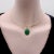 A bezel set malachite in 14k gold creates an oval-shaped pendant. Malachite—a green gemstone known for its beautiful...