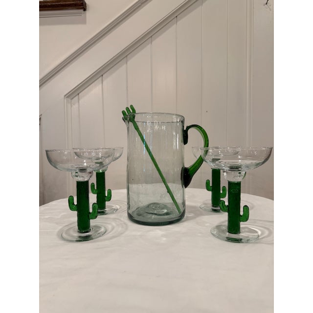 Bring a festive touch to entertaining with this charming Mexican-style blown glass margarita set. The collection includes...