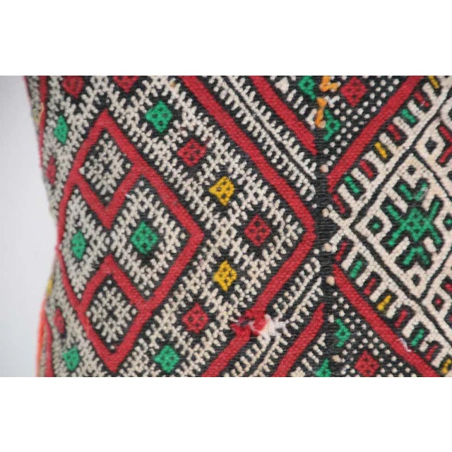 Moroccan Berber handwoven tribal throw pillow made from a vintage rug. The front and the back are made from a different...