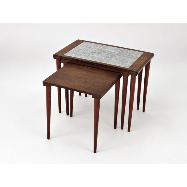 This is a set of three nesting tables originating from Denmark, produced during the 1960s. The design is characteristic of...