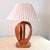 A wonderfully sculptural mid-century table lamp with a carved oak base featuring an open cutout form — organic, shield-...