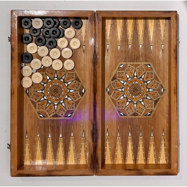 Immerse yourself in the storied craftsmanship of the Middle East with this spectacular vintage Syrian folding backgammon...