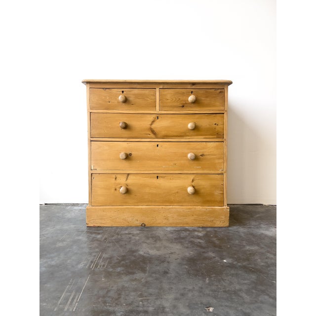 A charming antique 19th century English pine chest of drawers. Two over three drawer configuration with turned wooden...