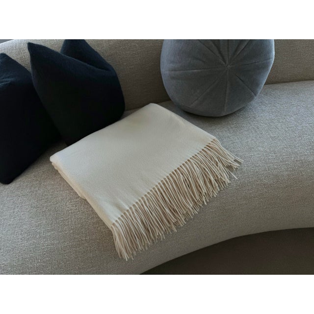 This cream-colored 100% cashmere throw by Ralph Lauren Home is like new. It would be a beautiful accessory in any...