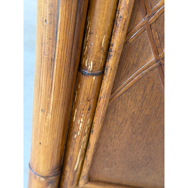 A charming vintage faux bamboo cabinet by Palecek featuring classic lattice detailing and playful pineapple motif doors....