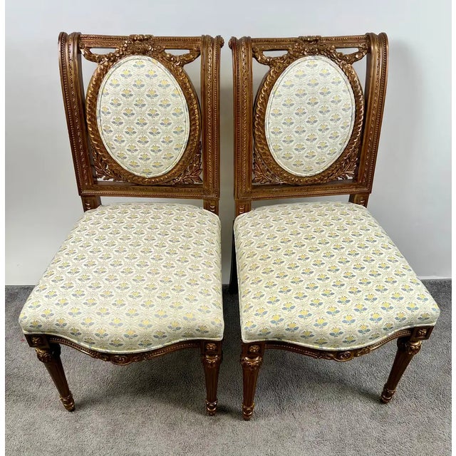 Pair of French Louis XVI-Style Carved Oak Side Chairs A refined pair of side chairs rendered in the classic Louis XVI...