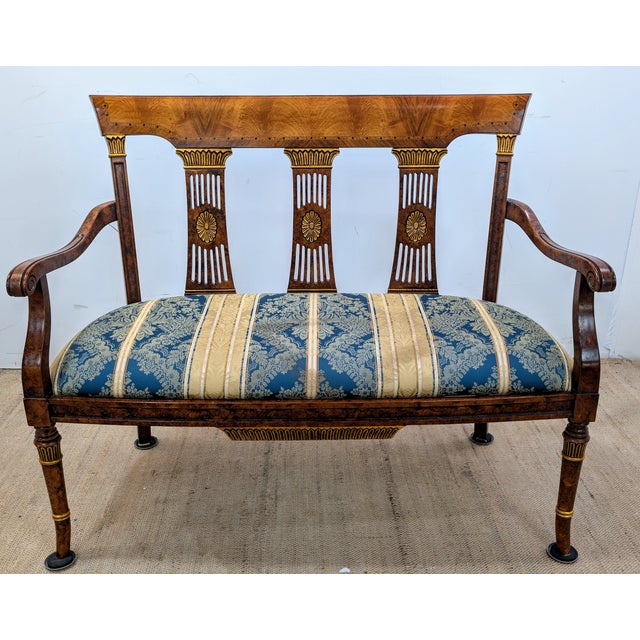 This exquisite Bench , rendered in a Neoclassical Style, crafted from a sumptuous mahogany. The bench is adorned with...