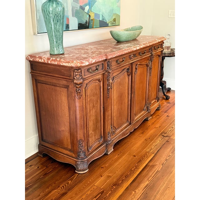 Gorgeous Louis XIV marble top walnut buffet. It’s beautifully adorned with elaborately detailed bronze hardware, fully...