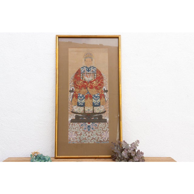 A framed Chinese ancestor portrait, measuring 26 inches wide and 48 inches high. This painting presents a dignified...
