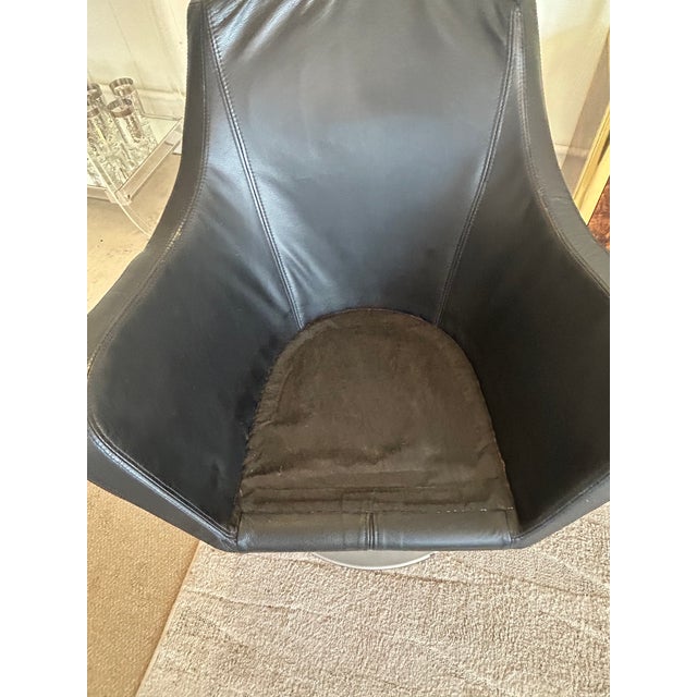 Stylish black leather and steel swivel club chairs attributed to Danish maker Bolia, having pedestal with round steel...