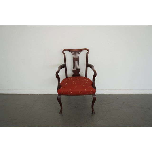A refined vintage mahogany armchair featuring an elegant lyre-back splat and graceful Queen Anne–style cabriole legs. The...