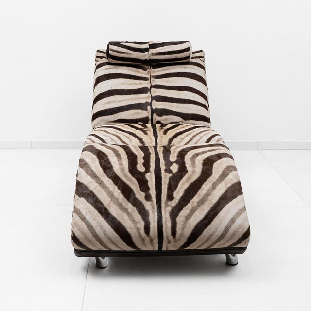 A stunning 1980s Italian chaise longue, featuring a sinuous, sculptural silhouette and upholstered in genuine zebra-print...