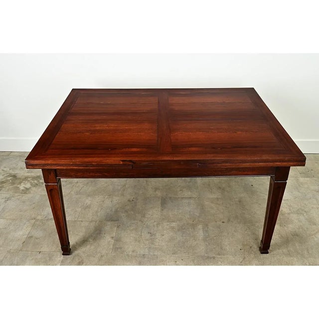 This rosewood extending dining table has self storing leaves making for a versatile dining table. This table easily seats...