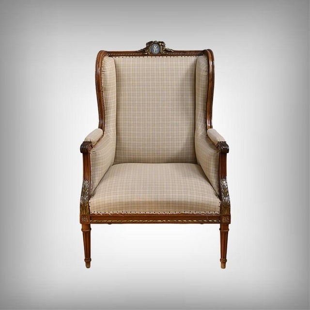A large Louis XVI-style wingback chair in walnut, this generously proportioned piece captivates with the balance of its...