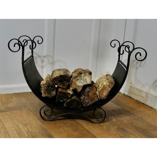 Wrought Iron Log Carrier This is a charming piece, it is made in iron and curved to carry logs, it stands on small curled...
