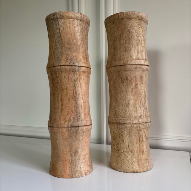 These beautiful candle holder pillars are carved of mango wood. Solid and very heavy. Natural finish. Measure 14 inches...