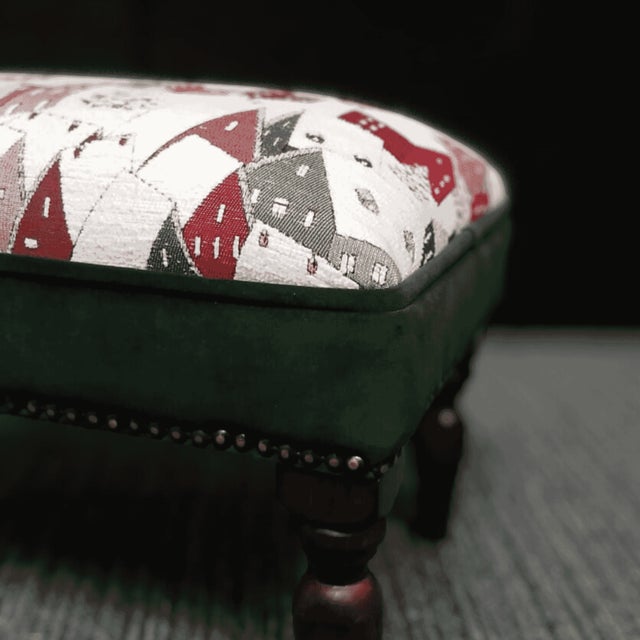 Meticulously handcrafted in the United Kingdom, this upholstered stool boasts classic studding and hand-polished solid...