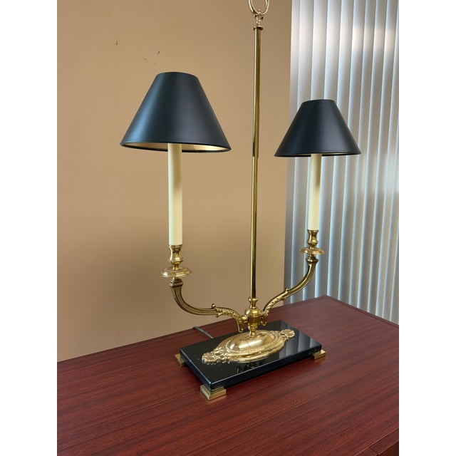 Handcrafted two-light table lamp featuring an ornate solid brass construction with detailed cast decorative elements. The...