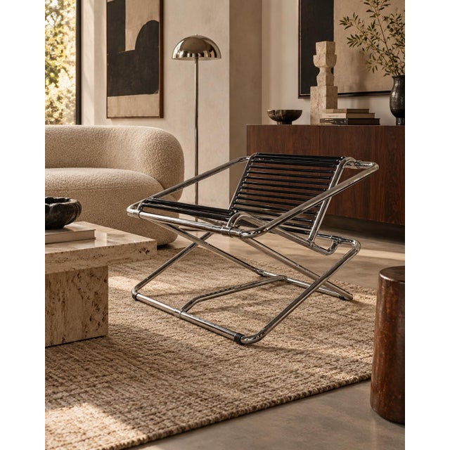 Iconic 1980s rocking chair designed by Ron Arad for One Off, England. Constructed from polished tubular chrome steel, the...