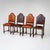 A set of four dining chairs from the Historicist period, crafted from intricately carved walnut. The chairs feature turned...