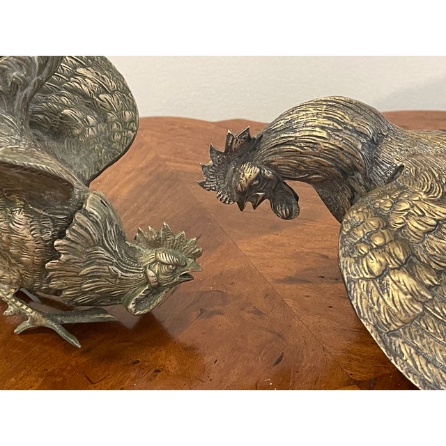 Antique pair of heavy ornate metal fighting roosters figurines.