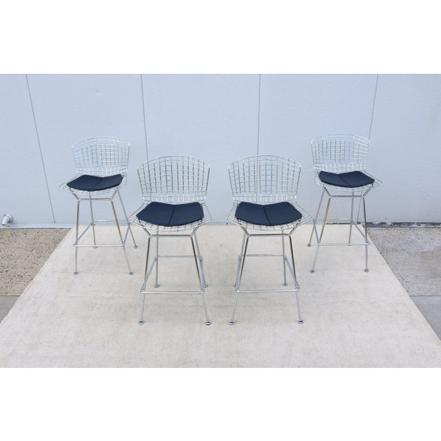 Fabulous, authentic mid-century modern set of four Bertoia bar height stools designed by legendary sculptor and designer...